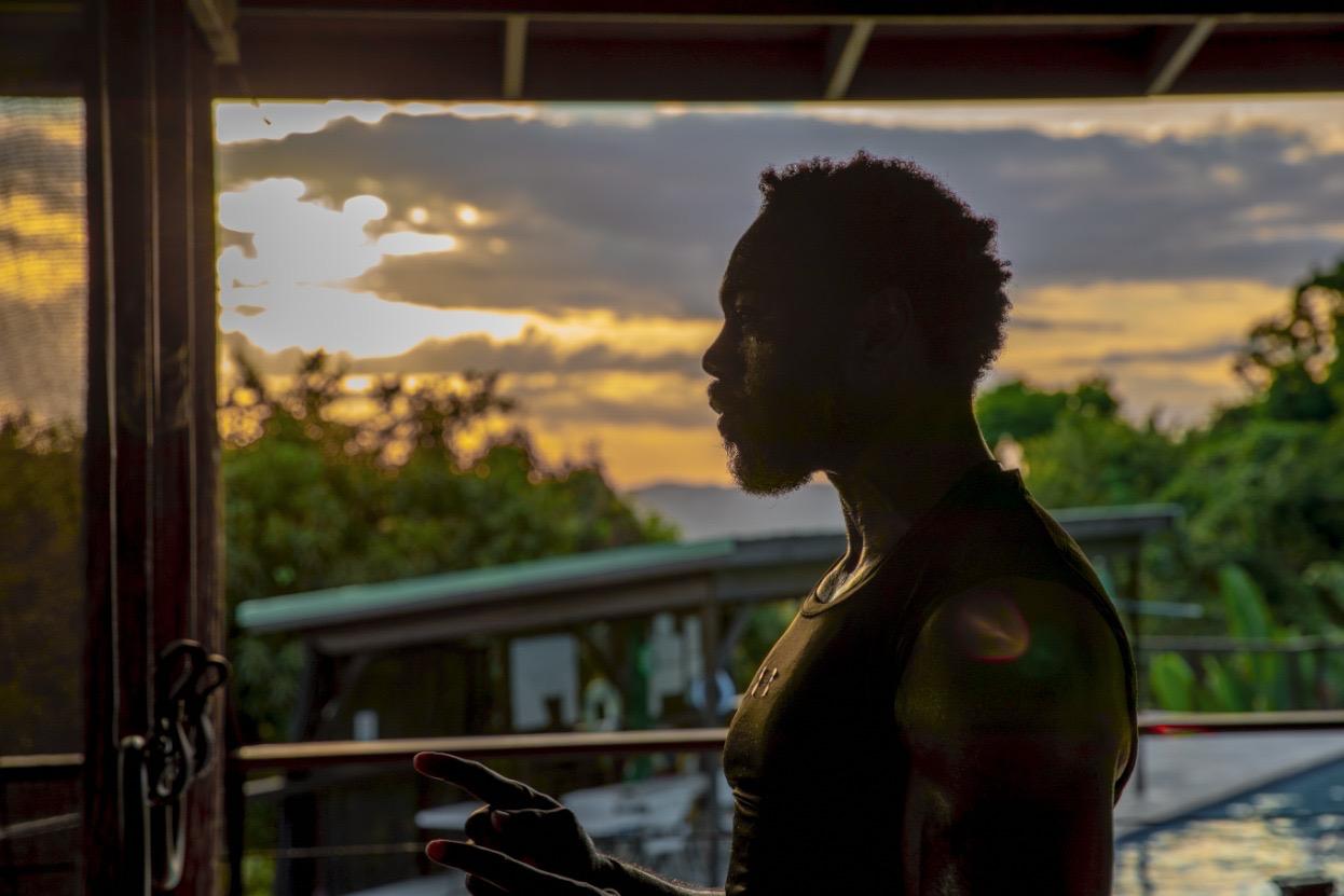 Eugene silhouette against vibrant Jamaican sunset