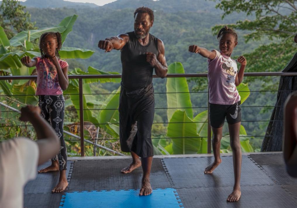 Eugene teaching kids martial arts stance in the mountains
