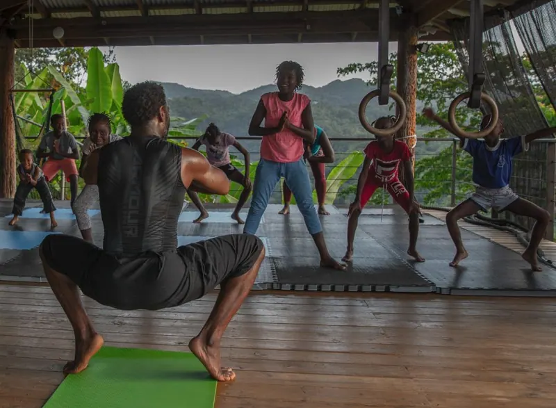 Wide shot of Eugene leading a group training session in Jamaica
