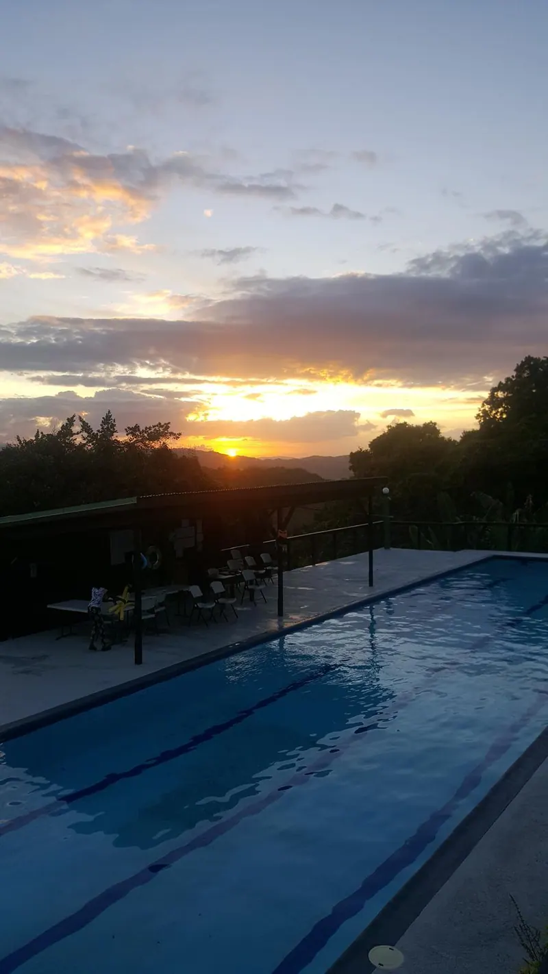 Wide sunset over the pool and mountain landscape